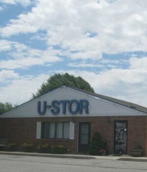 Main entrance of a self storage facility featuring a gated security system and signage
