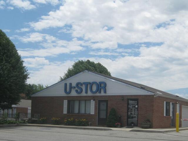 Main entrance of a self storage facility featuring a gated security system and signage