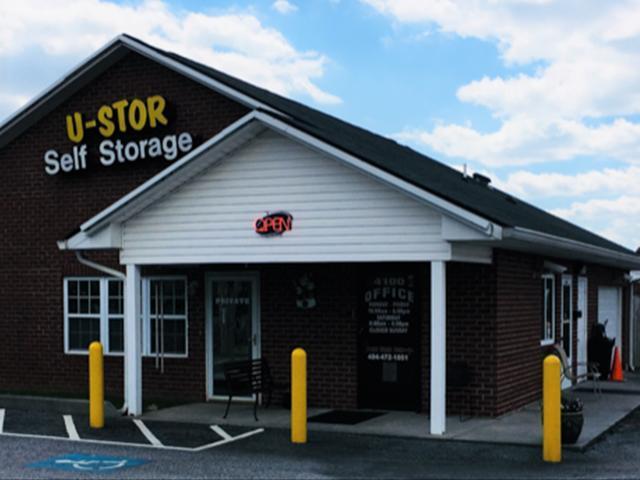 Friendly staff assisting customers at a self storage rental office