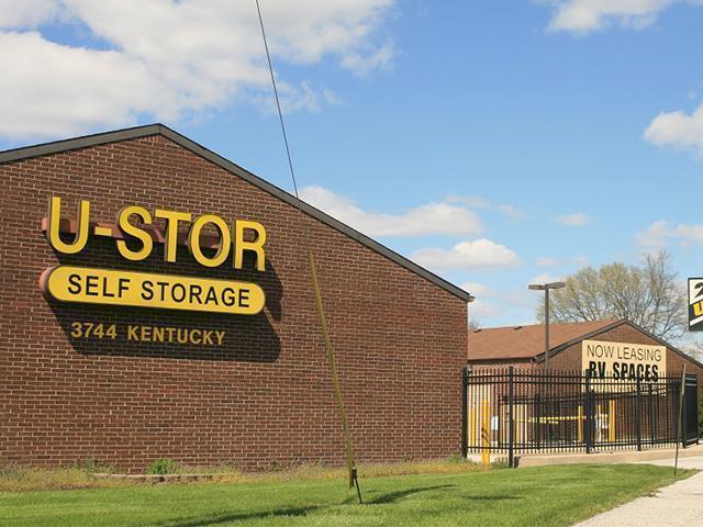 Signboard showing the name and contact information of a self storage facility USTOR