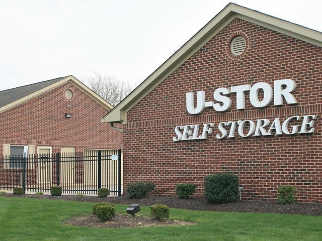 Well-lit self-storage facility hallway with modern security cameras mounted on ceiling, symbolizing safety guarantee.